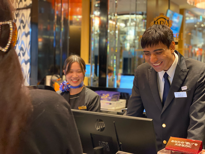 Karan in check in counter smiling while working